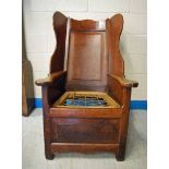 A late 18th century oak Wing Back Shepherds Chair, shaped back and side wings, curved sloping