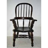 An early 19th century ash broad arm Windsor Chair, hooped spindle back, scroll terminal arms above