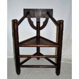 An early 20th century oak Arts and Crafts, Turners Armchair in the Warwick Design, Triangular form