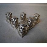 A set of six silver Place Card Holders modelled as Lions Mask on triangular base, 11.85oz
