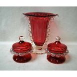 A large early 20th century Cranberry Glass Celery Vase with clear glass wavy sides and a clear foot,