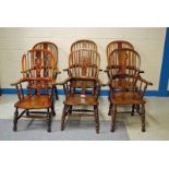 A Harlequin set of six early to mid-19th century ash and elm broad arm Windsor Chairs of typical