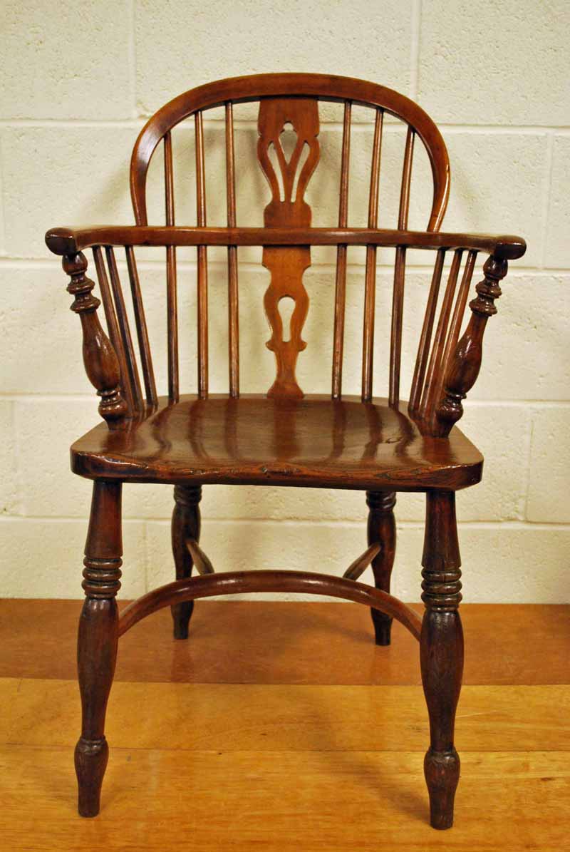 An early 19th century elm and ash Windsor Arm Chair of typical form, the low hooped back with