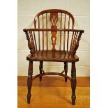 An early 19th century elm and ash Windsor Arm Chair of typical form, the low hooped back with