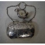 An Edwardian silver Ladies Purse of rounded rectangular cushion form, chased foliate decoration,