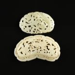 A GROUP OF TWO CHINESE CARVED AND RETICULATED CELADON JADE PENDANTS, POSSIBLY REPUBLIC PERIOD (