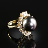 AN 18K YELLOW GOLD, PEARL, AND DIAMOND LADY'S RING, the mounting centering a Tahitian 13 1/2 mm
