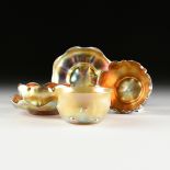 A FIVE PIECE GROUP OF LOUIS COMFORT TIFFANY IRIDESCENT GOLD FAVRILE GLASS BOWLS AND SAUCERS, EACH