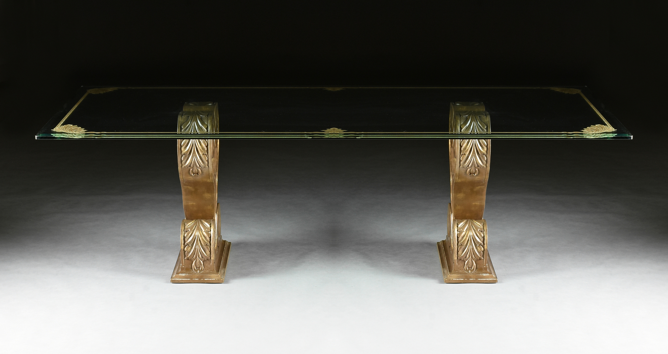 A HOLLYWOOD REGENCY STYLE GILT ETCHED GLASS TOP DUAL PEDESTAL DINING TABLE, MODERN, the