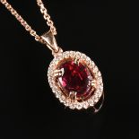 A 14K ROSE GOLD, RUBY, AND DIAMOND LADY'S PENDANT NECKLACE, the pendant set with an oval-cut ruby