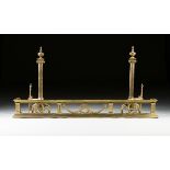 A PAIR OF FEDERAL STYLE POLISHED BRASS FIREPLACE ANDIRONS AND FENDER, 20TH CENTURY, the Ionic reeded