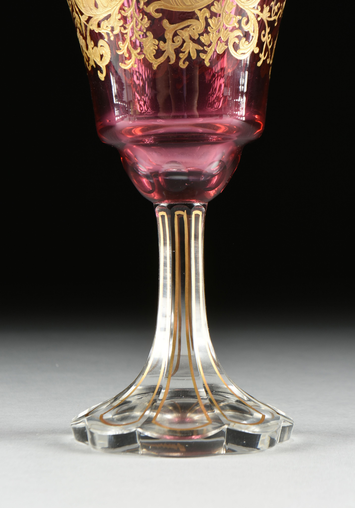 A SET OF FOUR BACCARAT STYLE GILT OVERLAY CRANBERRY TO CLEAR GOBLETS, CIRCA 1900, the gilt rims over - Image 5 of 8
