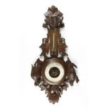A FRENCH BLACK FOREST STYLE CARVED WOOD BAROMETER ANEROID, EARLY 20TH CENTURY, with a carved