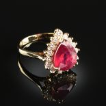 A 14K YELLOW GOLD, NATURAL RUBY, AND DIAMOND LADY'S RING, the mounting centering a pear-shaped