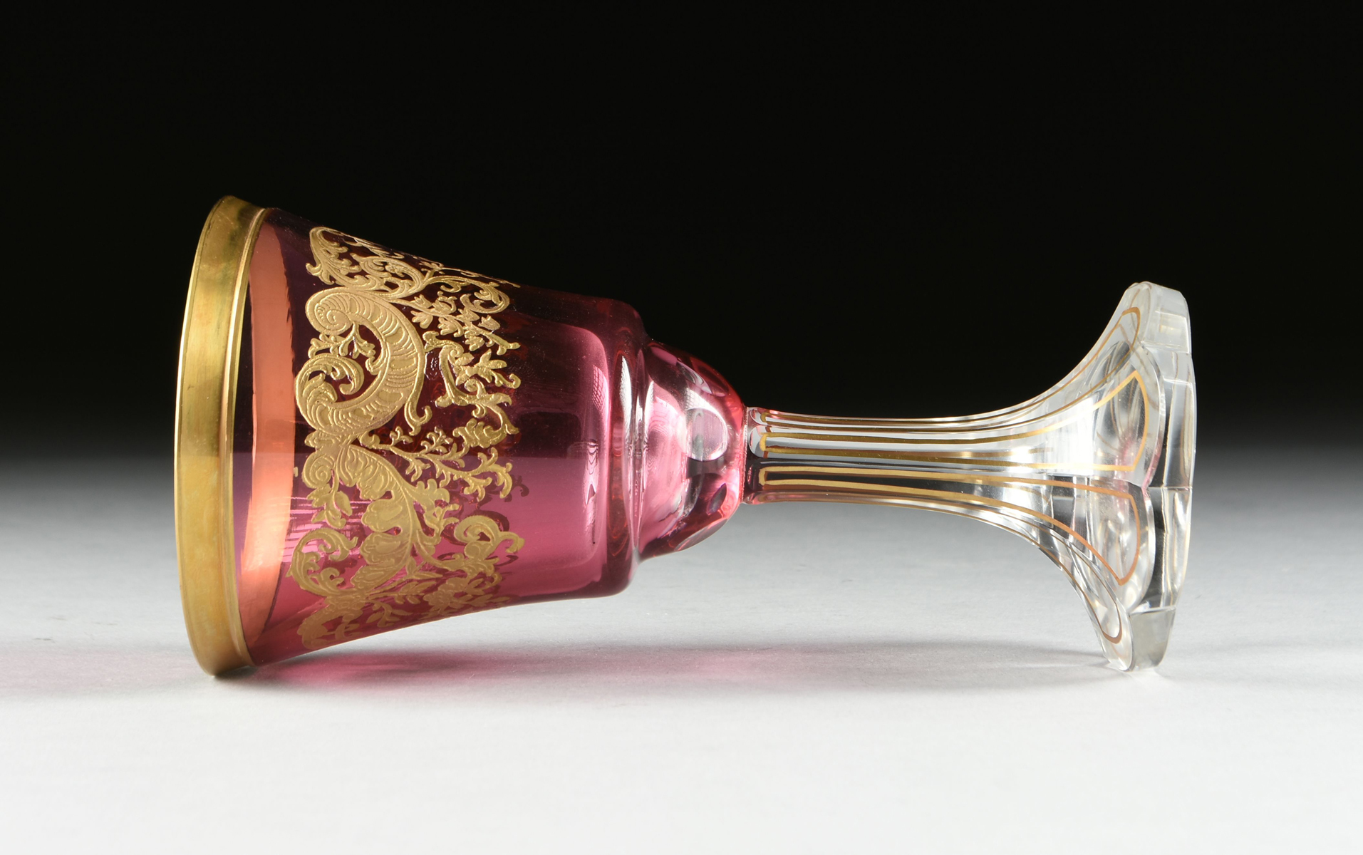 A SET OF FOUR BACCARAT STYLE GILT OVERLAY CRANBERRY TO CLEAR GOBLETS, CIRCA 1900, the gilt rims over - Image 6 of 8