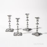 Four George II Sterling Silver Candlesticks, London, each with engraved armorial or coat of arms