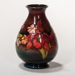 Moorcroft Pottery Orchid Design Flambe Vase, England, c. 1935, polychrome enameled to a red