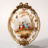 Hand-painted Earthenware Plaque, France, c. 1900, gilt-metal-mounted shield shape gilded and