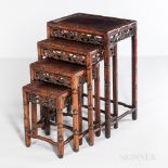 Four Carved Hardwood Nesting Tables, China, 20th century, top panels set in carved frames depicting