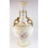 A large Edwardian vase painted flowers on an ivory blush ground with gilt scrollwork handles -