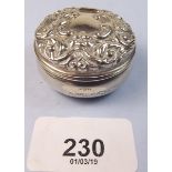 A silver pill box with embossed decoration Birmingham 2000