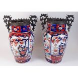 A pair of mid 19th century Imari vases with metal rims - 25cm tall