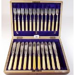 A set of twelve silver collared fish knives and forks