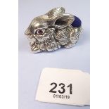 A silver rabbit pin cushion