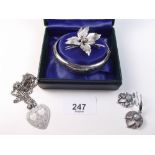 A silver hinged bangle, silver brooch and silver plated necklace and earrings