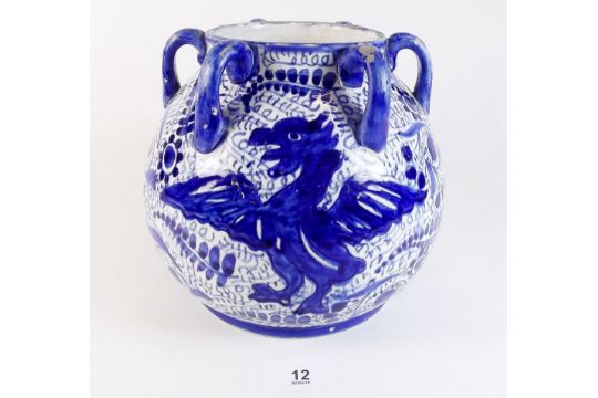 A 19th century continental faience six handled blue and white pot painted dragon