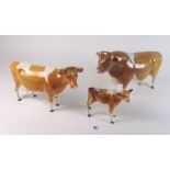 A Beswick Guernsey bull, cow and calf