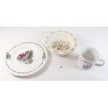 A Doulton Bunnykins baby dish, a Wedgwood Peter Rabbit plate and mug
