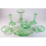 A vintage green glass dressing table set