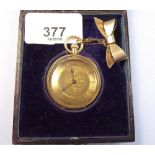 An 18k gold continental fob watch with silver bow brooch