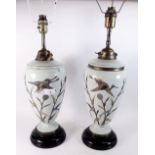 A pair of Victorian green porcelain table lamps painted birds - 37cm high - both a/f