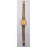 An Omega 9 carat gold ladies quartz wrist watch with fancy 9 carat gold strap