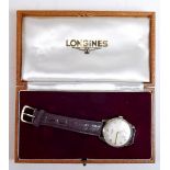 A 9 carat gold Longines gentleman's wrist watch with leather strap - original fitted box and receipt