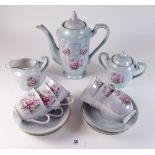 A vintage coffee set printed roses comprising coffee pot, six cups and saucers, milk and sugar