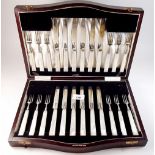 A mother of pearl handled silver dessert service of twelve knives and forks by Cooper Brothers,