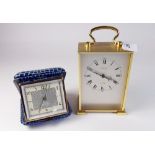 A modern Looping eight day alarm carriage clock and a Blessing eight day travel alarm clock in
