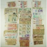 A wad of world banknotes 60 plus. Examples Bank of England 10 shillings and Green £1, Belgium,