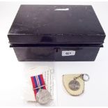 A metal strong box, key ring and service defence medal 1939 - 45