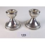 A pair of squat silver candlestics