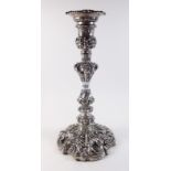 A silver Rococo style candlestick with all over floral and shell design by Walker and Hall,