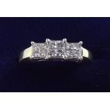 An 18 carat gold three stone diamond ring - size S