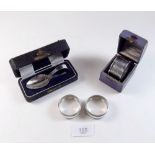 A silver christening spoon 1925 and a silver napkin ring 1921 - both boxed plus a pair of silver