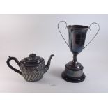 A silver plated trophy cup and a teapot