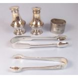 A silver salt and pepper - Birmingham 1945, a silver napkin ring - Birmingham 1958, and two pairs of