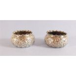 A pair of silver circular salts with embossed decoration - Birmingham 1890