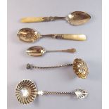 A continental silver sifter spoon, a white metal one and two silver plated preserve spoons